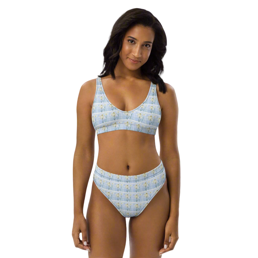 Woman wearing a light blue bikini with a subtle pattern on a white background